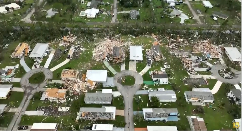 Aerial view of a neighborhood with buildings partially to completely smashed into debris.