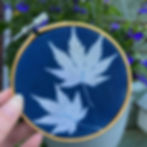 A blue and white print with beading depicting botanical shapes.