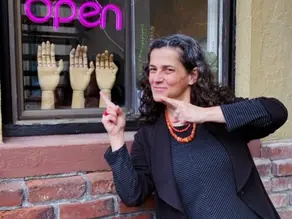 Curator daria Loi in front of her art gallery, imperfecta.