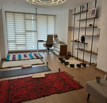 Serene yoga studio of Kriti Mathur with mats for the students, singing bowls used during the session