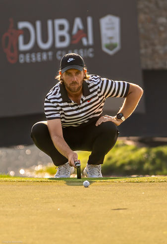 Tommy Fleetwood lines up a putt on the 13th hole at the Emirates Golf Club's Majlis Course - Hero Dubai Desert Classic 2025
