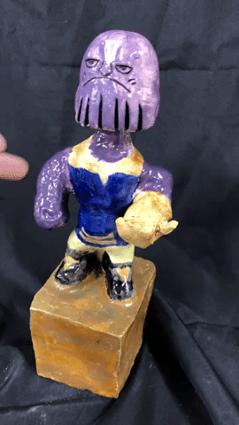 Video of student ceramic bobble head of comic book character