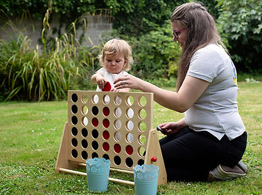 bridesmaid and nanny playing with connect four