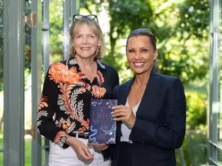 Vanessa Williams speaking during a professionally filmed podcast interview in a warm, natural home setting with a three-camera setup