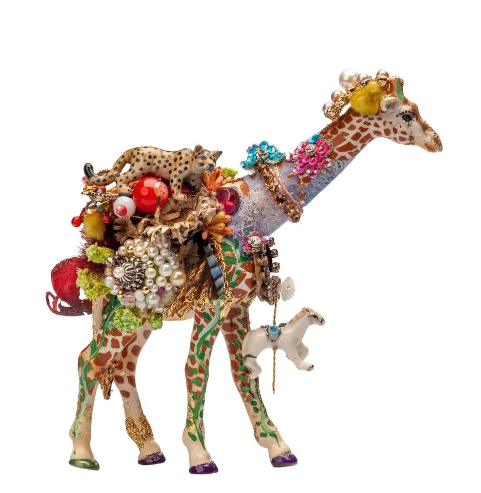 Decorated toy giraffe witha small giraffe hanging from his neck.