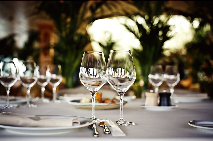 Close-up of an elegant wedding table setting featuring two empty wine glasses, highlighting sophisticated decor and bridal celebration themes.