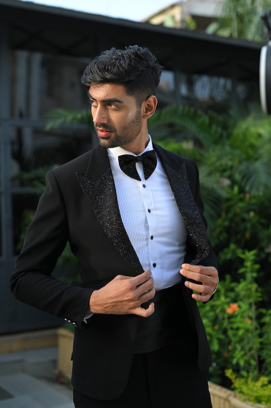 Close-up of black Japanese crepe tuxedo showcasing hand-embroidered kaddana detailing on the satin lapels.