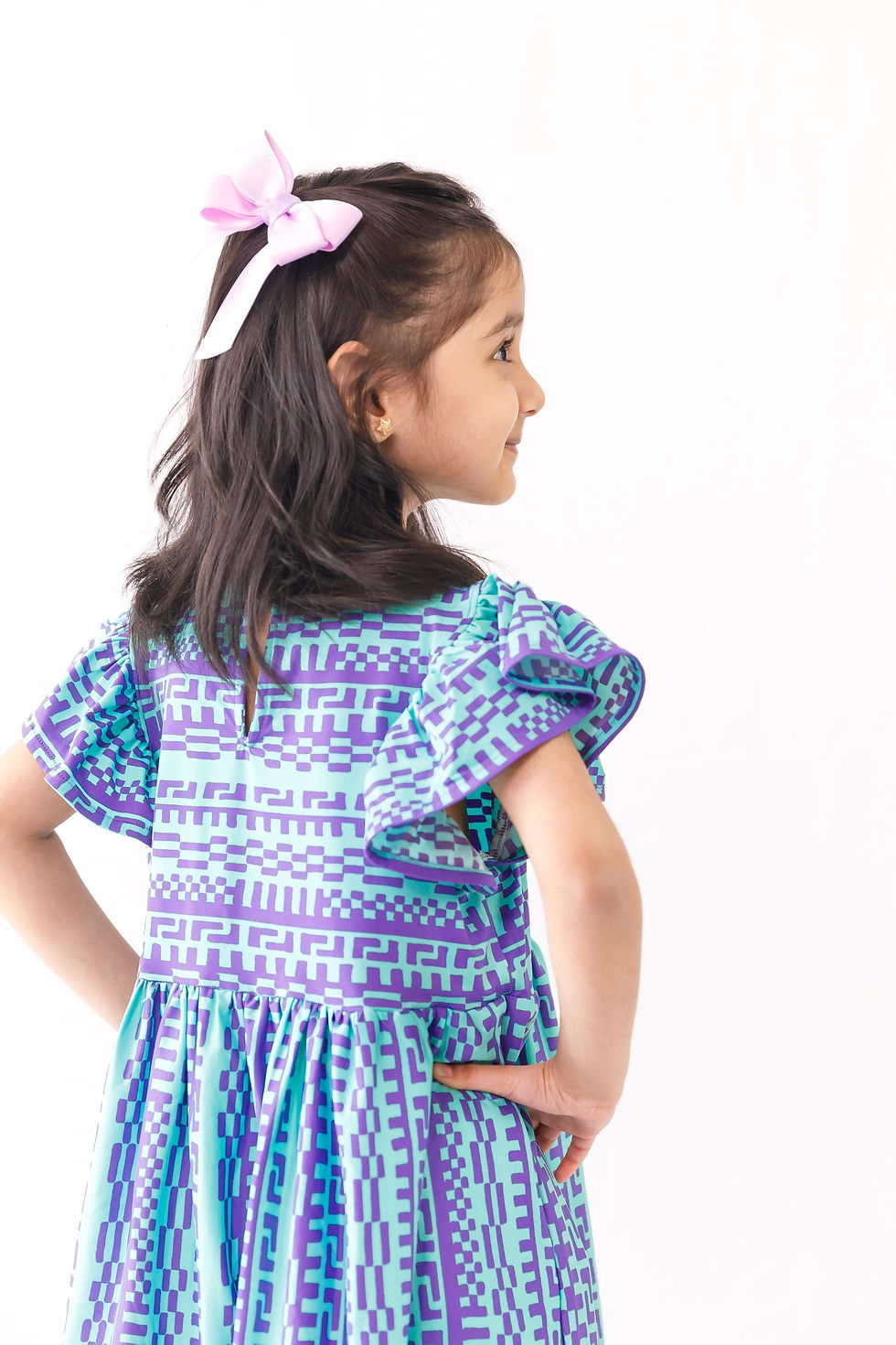 Thumbnail: cyan geometric pattern dress, with a ruffled sleeve and a button loop at the center back