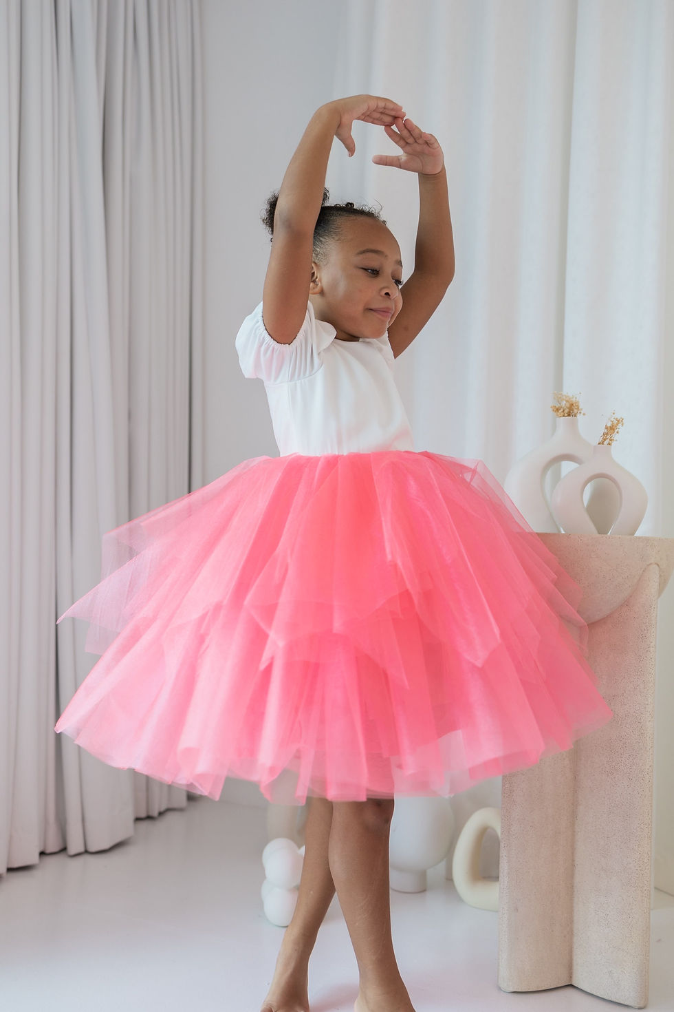 Thumbnail: Loveth dress combines a pristine white top with a delightful peach tulle skirt