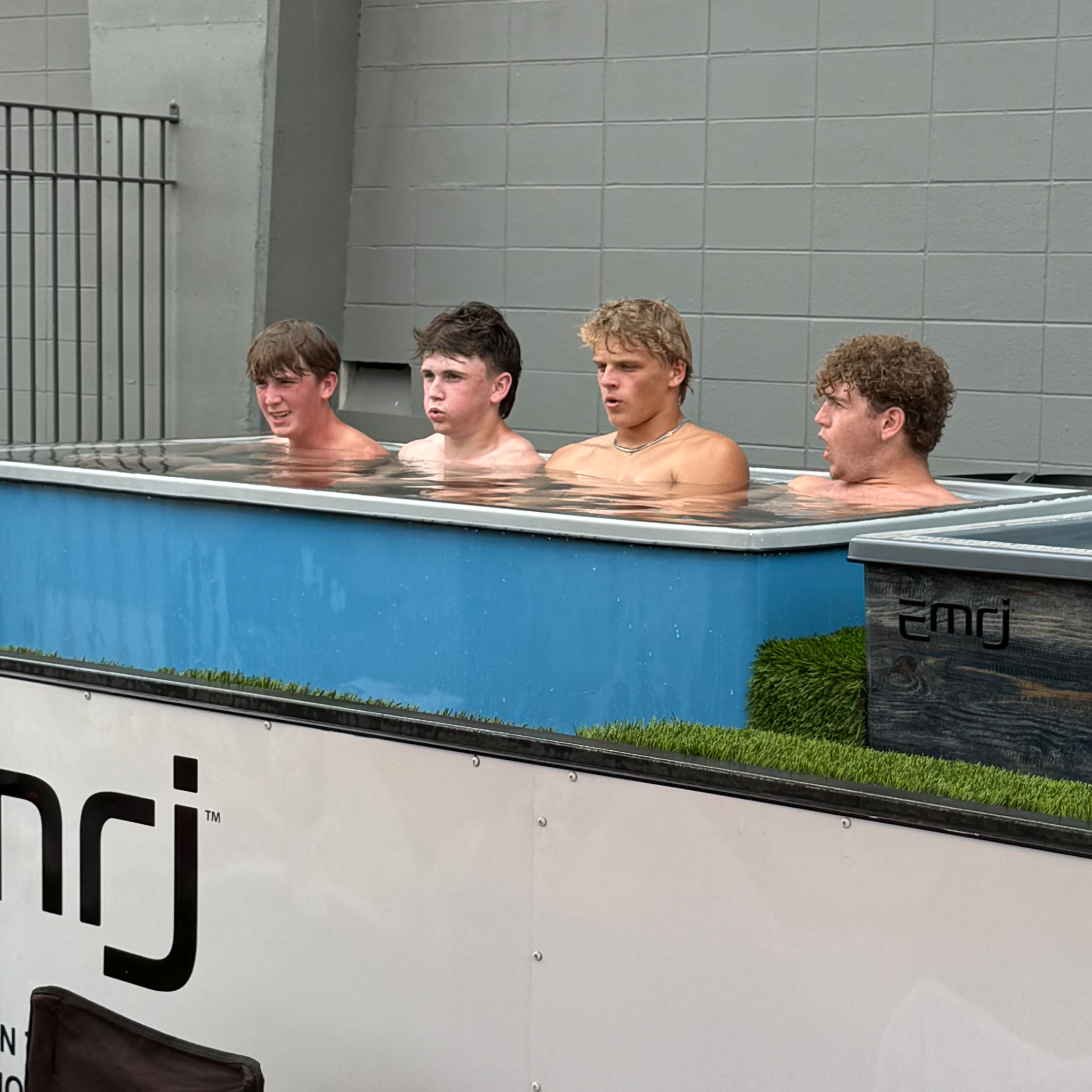 Four athletes immersed in a blue UNITED pod at the Manning Passing Academy