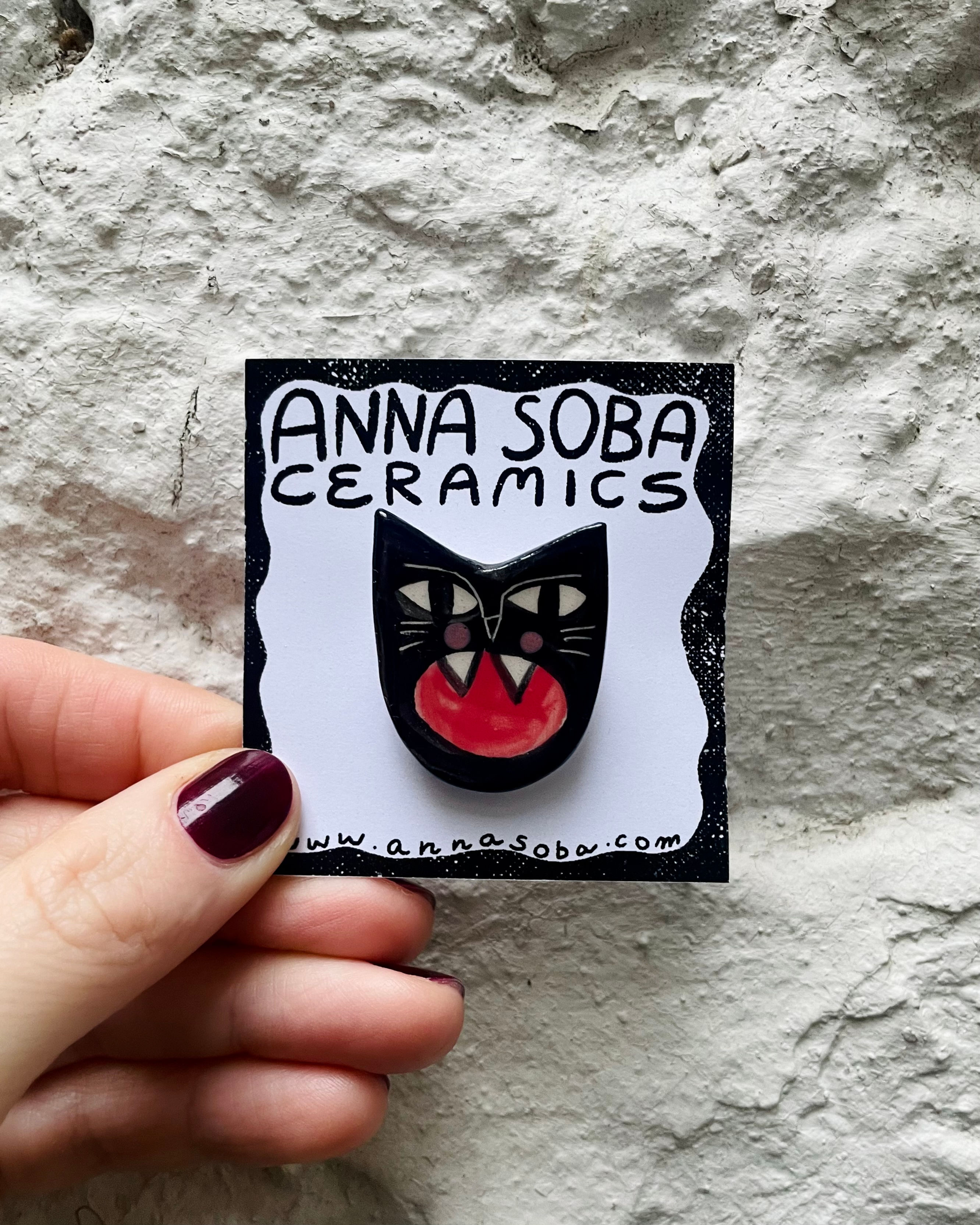 Ceramic brooch, angry cat