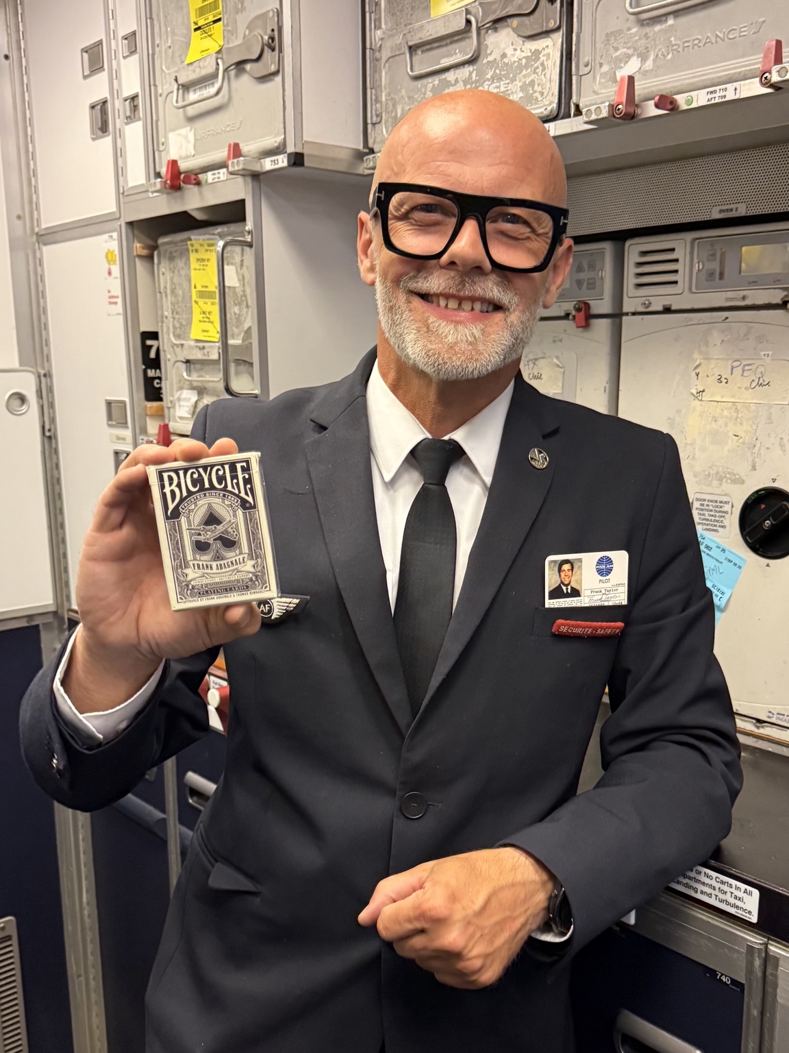 Cabin crew professional holding the Frank Abagnale deck
