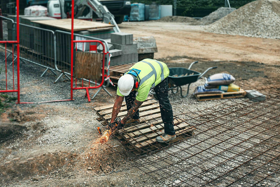 Worker in government funded construction training using a power tool.