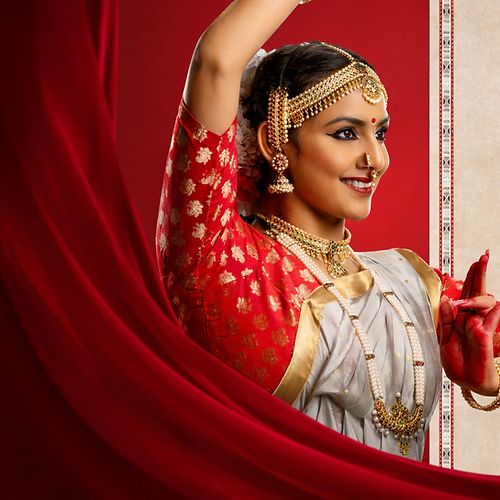 Elegant Bharatanatyam dancer in traditional attire.png
