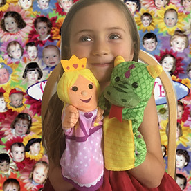 beautiful girl with puppets at a zoom program with Miss Sherri
