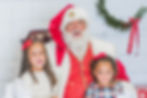 Santa posing with 2 little girls