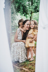 little girls hugging their mom