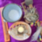 Shamanic ritual items, including salt, incense, sage and a tea light.