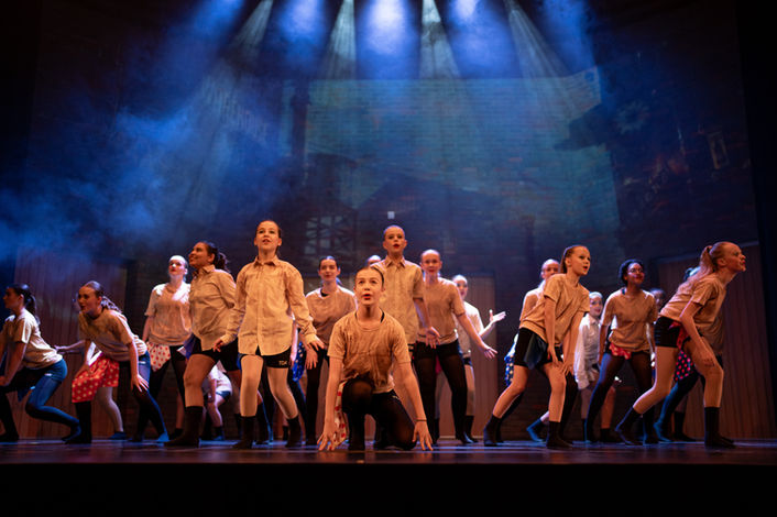 Youth dance group performing on a stage