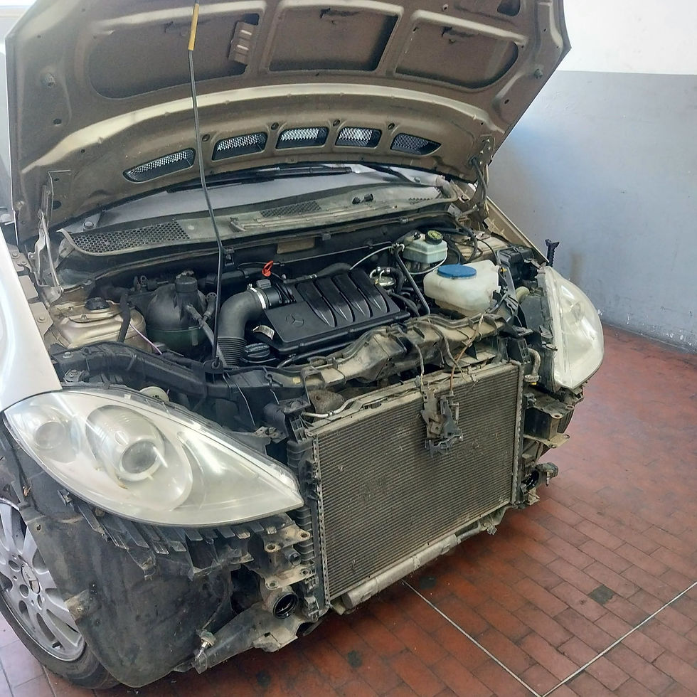 Mercedes con cofano aperto e paraurti anteriore rimosso per accedere ai componenti dell’impianto di climatizzazione.