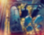 Industrial plant with large metal tanks and pipes, warm lighting.