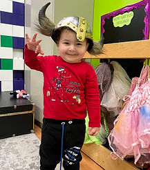 Little boy playing dress up in Drama Class