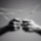 Hands playing cats cradle string game with black and white grainy photo style.jpg