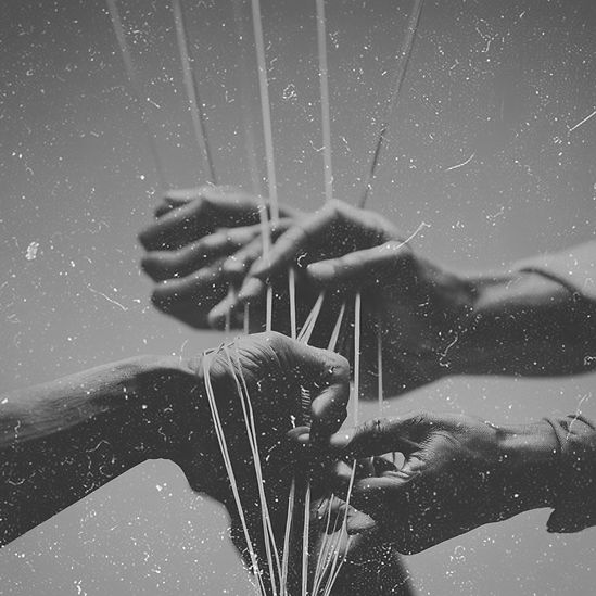 Black Hands playing string game black and white grainy photo style.jpg