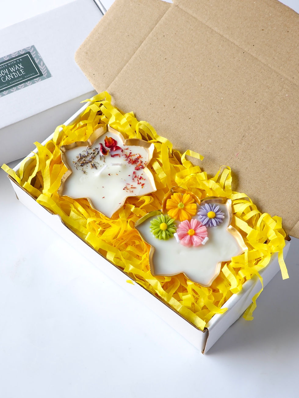 Pack of 2 scented soy wax urli candles inside a gift box with paper filler