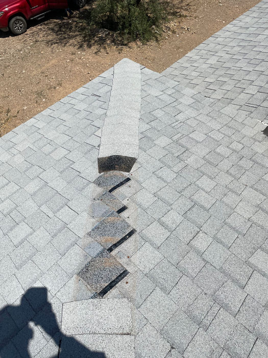 “Section of a residential roof with missing asphalt shingles, exposing underlayment and increasing risk of leaks and water damage.”