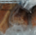 Loaves of bread wrapped up and in freezer as a way to make healthy bread last longer e.g sourdough