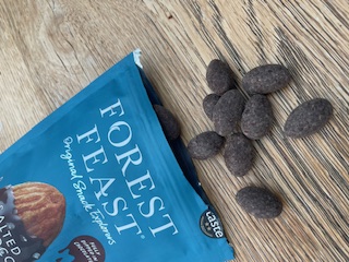 dark chocolate almonds on work desk as healthy snack