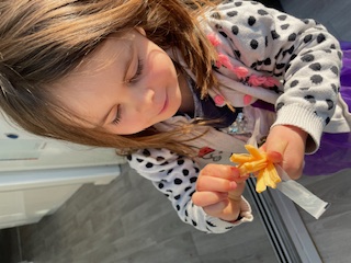 toddler enjoying a cheesestring - good nutritionist approved snack 