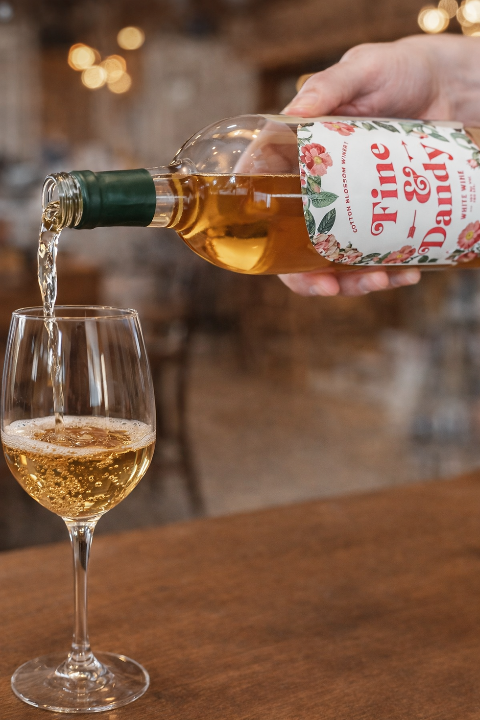Pouring Fine & Dandy white wine.png