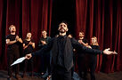 expressionalible-guy-practicing-his-role-group-actors-dark-colored-clothes-rehearsal-theat