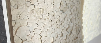 Giant's Causeway-inspired concrete fragments arranged in grids, a sculpture exploring natural self-organization and pattern.