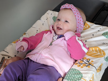 Baby smiling during chiropractic adjustment