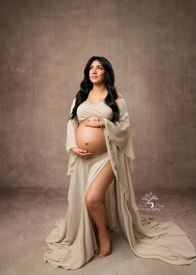 maternity photography using a beige backdrop and silky, flowy,beige dress
