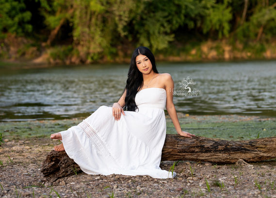 class senior photography  at a creek location using a white boho dress 