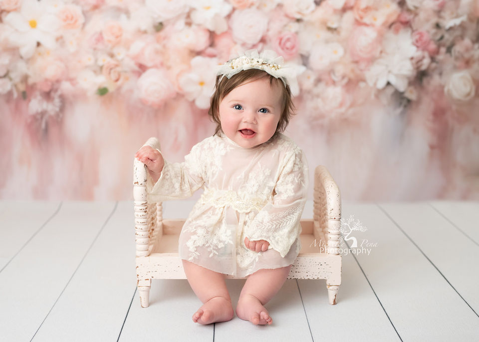 baby photoshoot with a baby girl using pink floral and long sleeve lace outfit