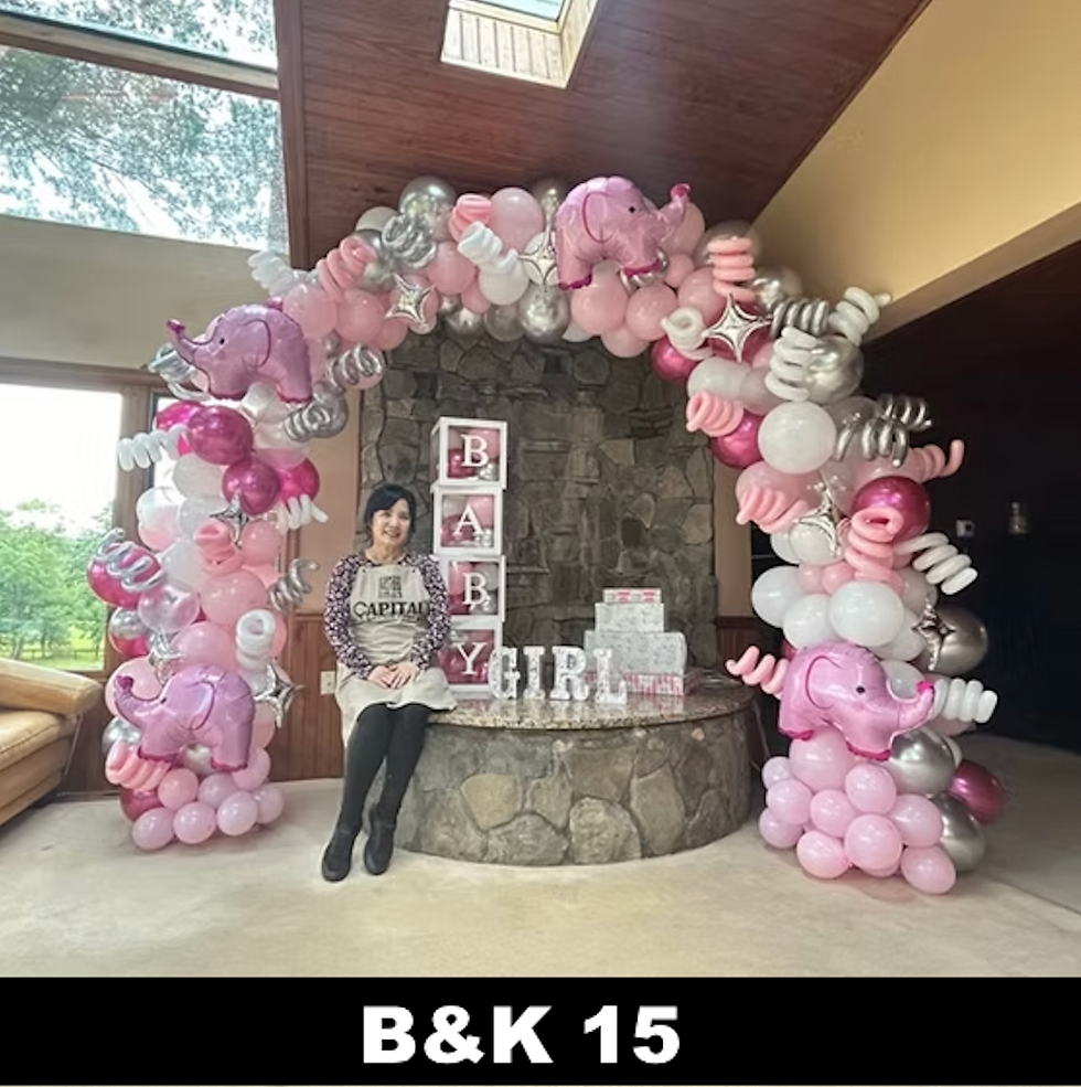 Woman sits by pink elephant balloon arch at a baby shower; stacked blocks read BABY GIRL, with B&K 15 below.