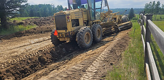 Road widening with grader in Bragg Creek