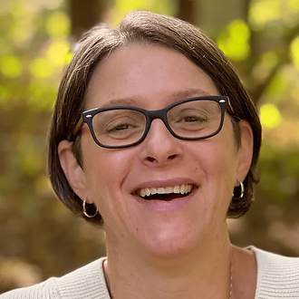Smiling woman with glasses on the Board of Directors