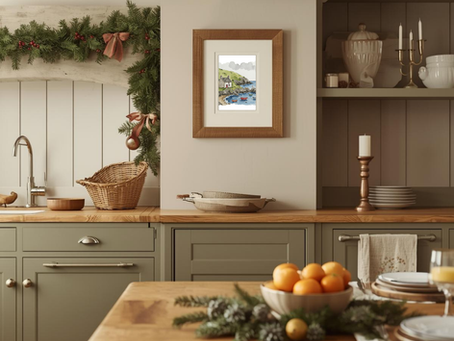 A cornish cove art print is framed in a traditional kitchen