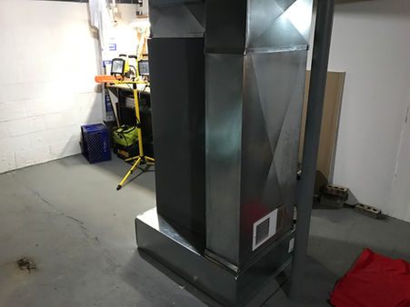 A large AC unit in a basement installed by Buckeye Mechanical