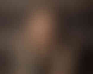 Woman in studio setting, conveying openness and strength.