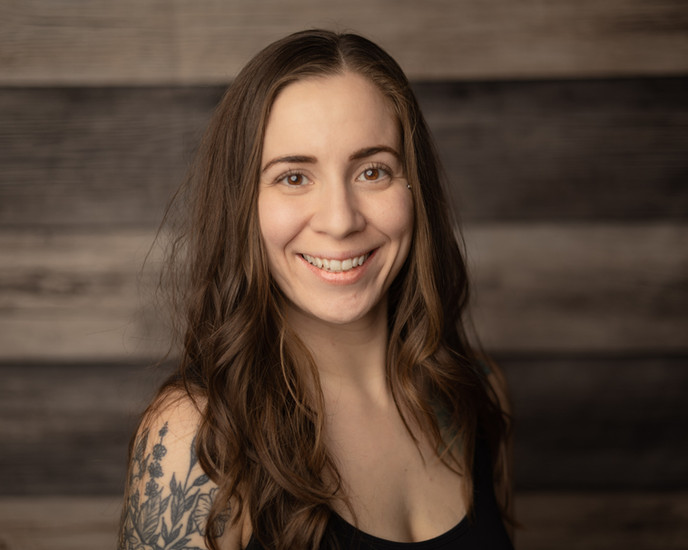 Portrait of a woman with soft lighting emphasizing facial expressions.