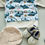 Miniaturbild: Lederpuschen für Babys und Kleinkinder in creme mit gesticktem Anker Wappen und Babypullover in Beige mit Haifisch Motiv