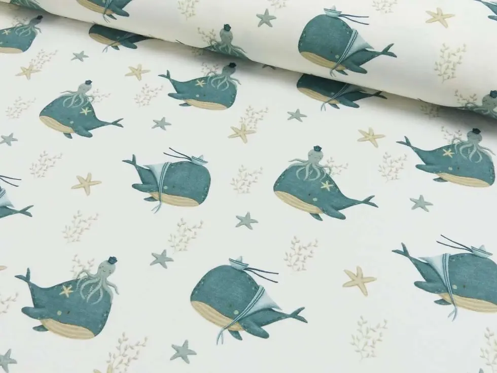 Miniaturbild: Detailaufnahme des maritimen Baumwolljerseys mit Walen, Seesternen und Unterwassermotiven. Das Futter der Kollektion „Walträu