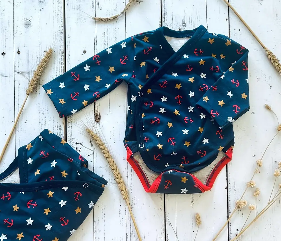 Baby trägt das maritime Babyset Sternenzauber mit Wickelbody und Pumphose aus weichem Jersey. Handgemachte Babykleidung aus O